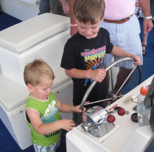 boys driving boat